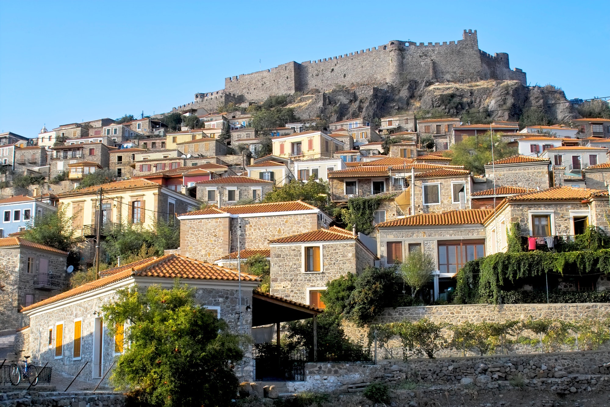 Castle looking over Molyvos village on Lesbos, Greece. Homes & houses on the hill.